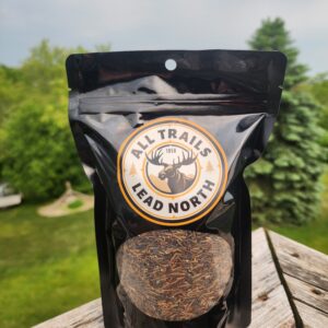 16 oz bag of cultivated wild rice from All Trails Lead North on rustic background